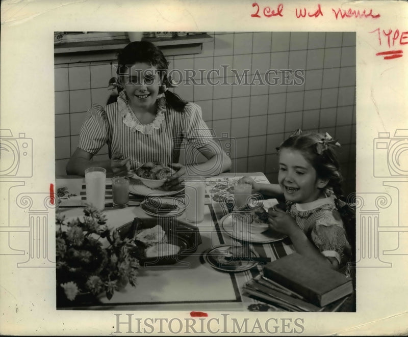 Load image into Gallery viewer, 1944 Press Photo A couple of girls eating a hearty breakfast
