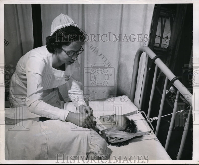 Load image into Gallery viewer, 1950 Press Photo Patient Vivian treated for child arthritis by a nurse
