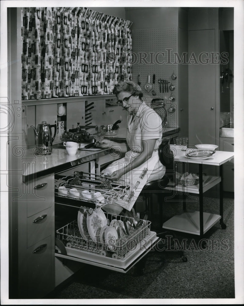 1956 Press Photo A hommemaker at kitchen sink with a dishwasher