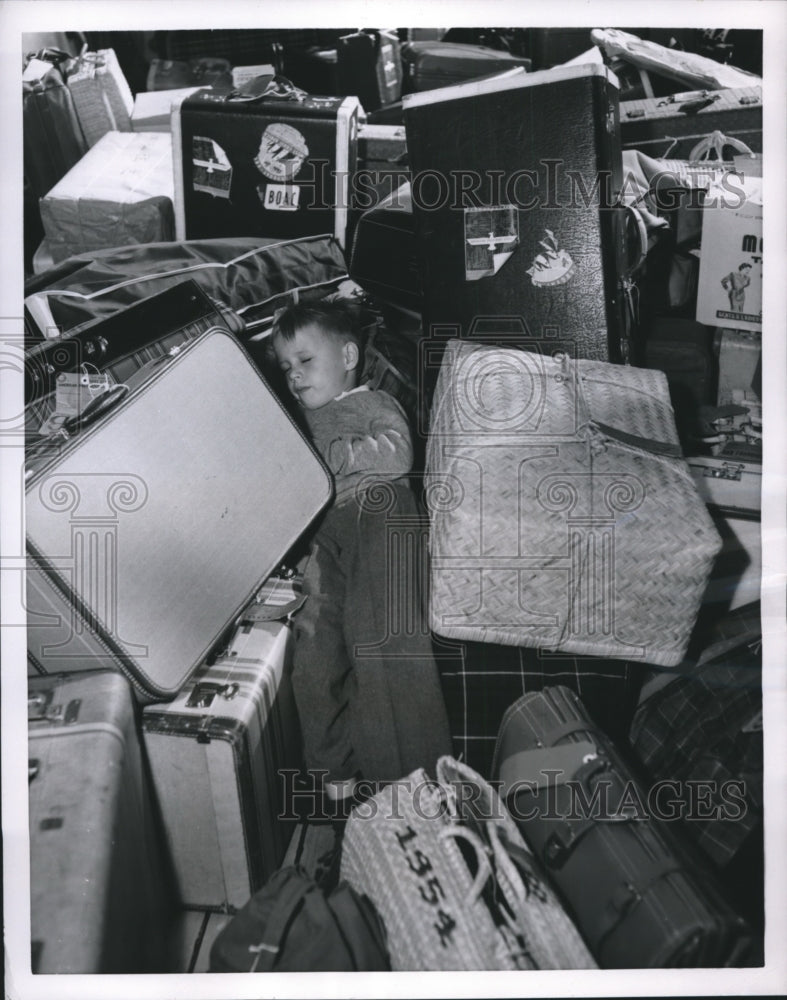 Load image into Gallery viewer, 1955 Press Photo Tracy Jones Naps Among Luggage Aboard SS President Cleveland
