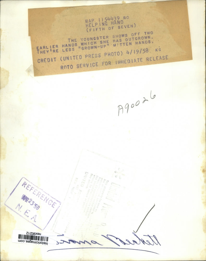 1958 Press Photo Little Girl Holds Mitten Hands