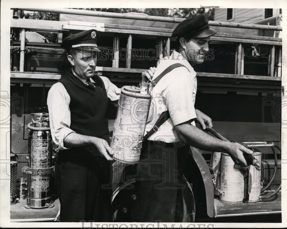 1941 Press Photo Fire Chief Ted Kekic Jr Straps Indian Fire Fighter on Brother