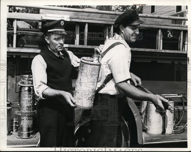 Load image into Gallery viewer, 1941 Press Photo Fire Chief Ted Kekic Jr Straps Indian Fire Fighter on Brother

