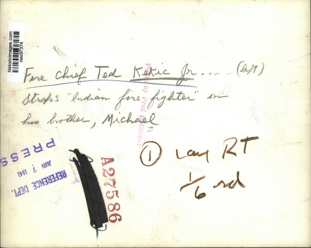 1941 Press Photo Fire Chief Ted Kekic Jr Straps Indian Fire Fighter on Brother