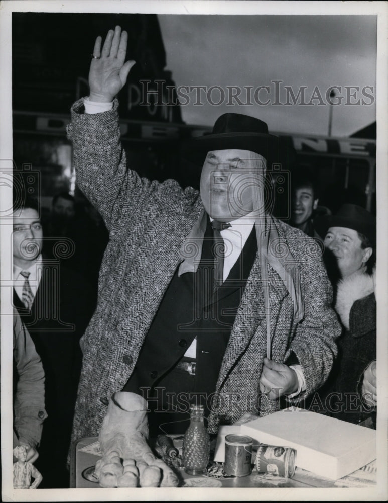 1958 Press Photo Max Dupuis Puts Nylon Stockings on His Face in Paris