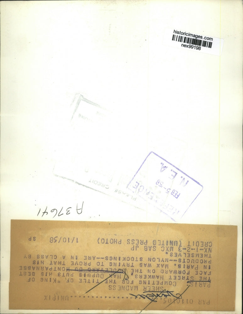 1958 Press Photo Max Dupuis Puts Nylon Stockings on His Face in Paris