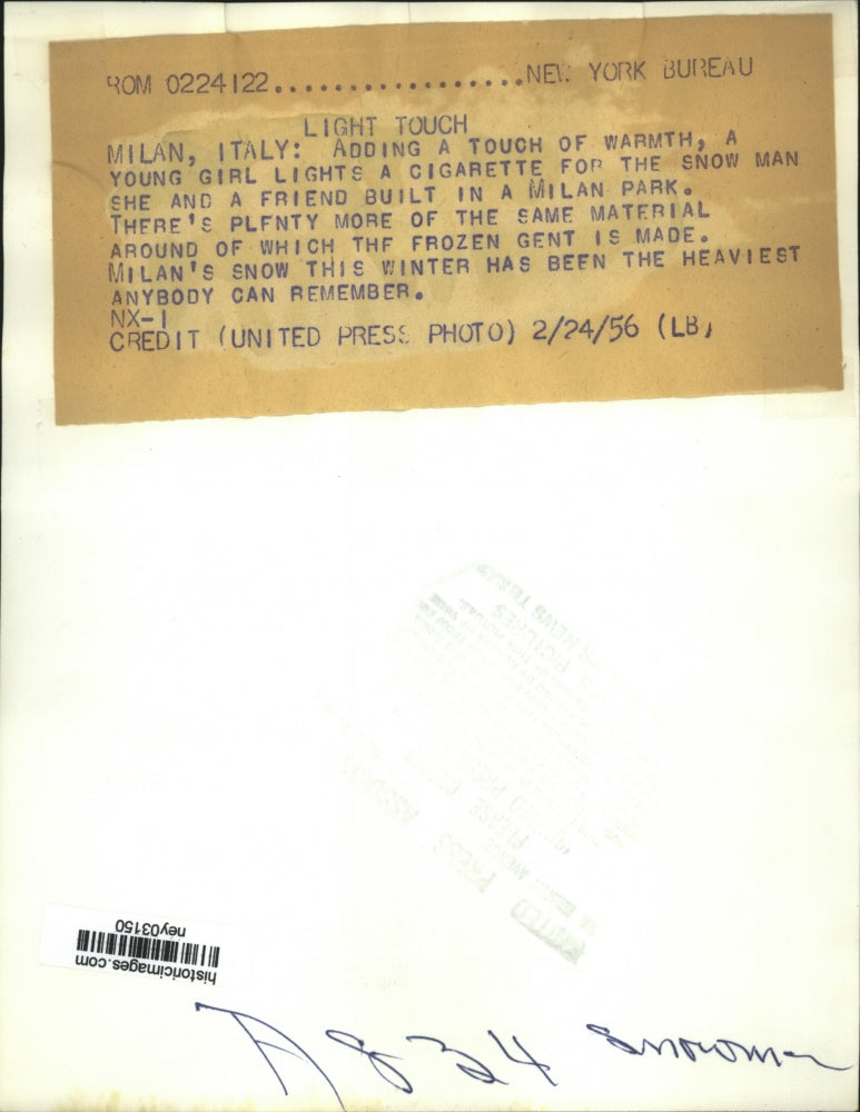 1956 Press Photo Girl Lights Cigarette for Snowman in Milan Park Italy