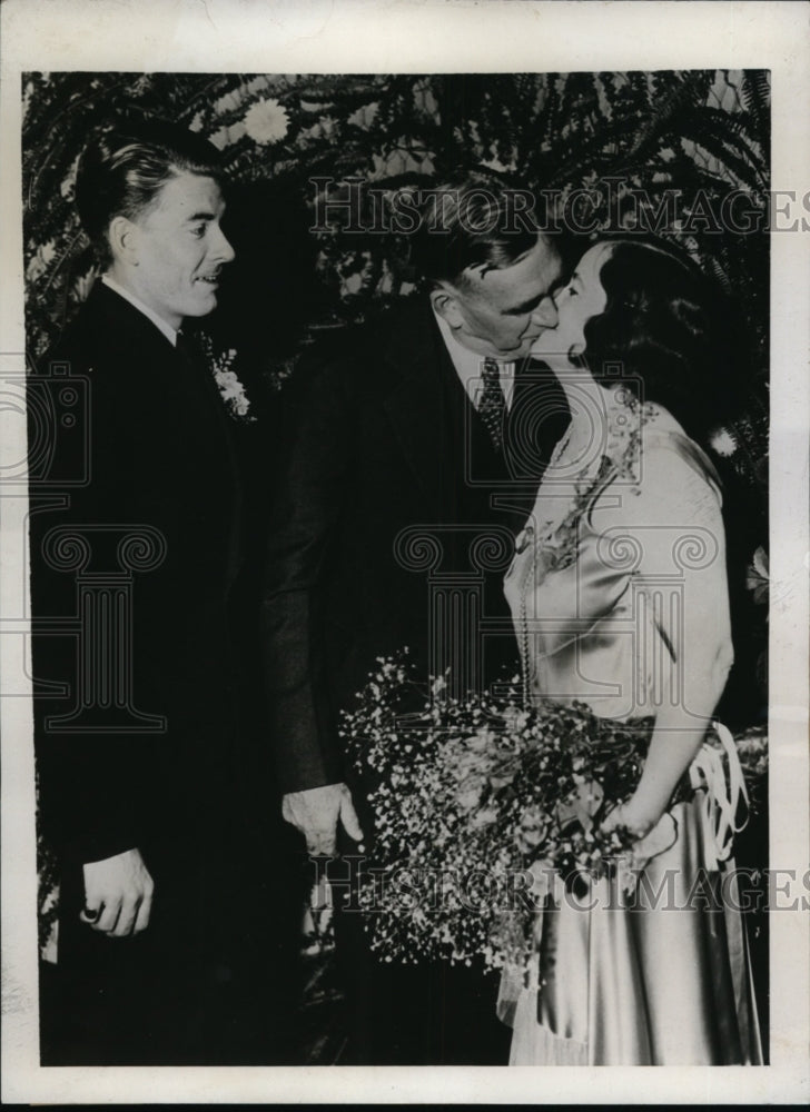 Load image into Gallery viewer, 1933 Press Photo Dr EB Troy kisses Mrs FLorence Bown while her groom looks on
