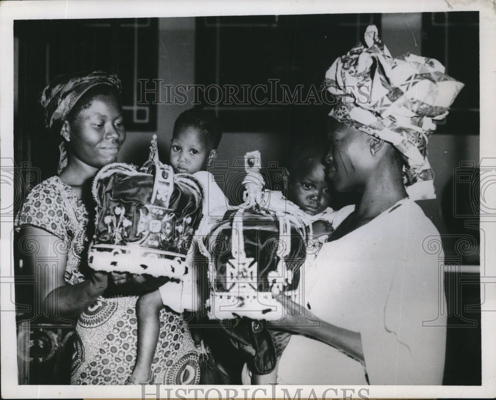 1956 Press Photo Nigerian Native Mothers Hold Both Babies & Crown Jewel Replicas