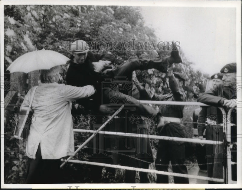 Load image into Gallery viewer, 1963 Press Photo Demonstrator Hoisted Over Gate at Germ Research Center, England
