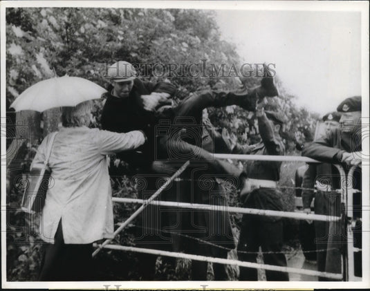 1963 Press Photo Demonstrator Hoisted Over Gate at Germ Research Center, England