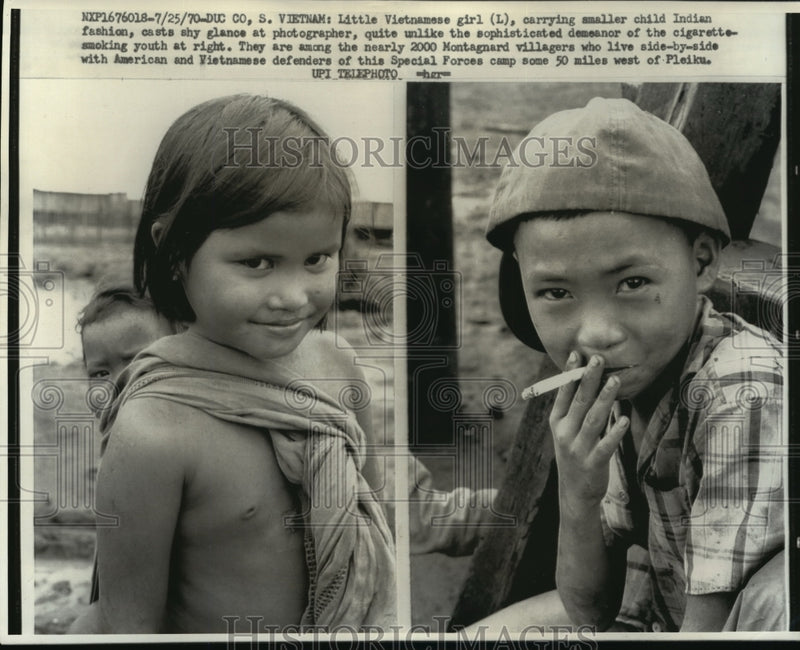 Load image into Gallery viewer, 1970 Press Photo Vietnamese Girl &amp; Boy Smoking Cigarette in Montagnard Village

