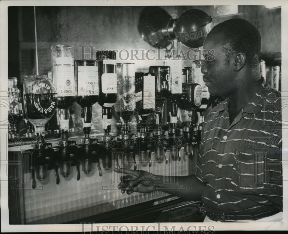 1957 Press Photo Bartender Allen B. Jones Demonstrating Shot Lever Dispensers