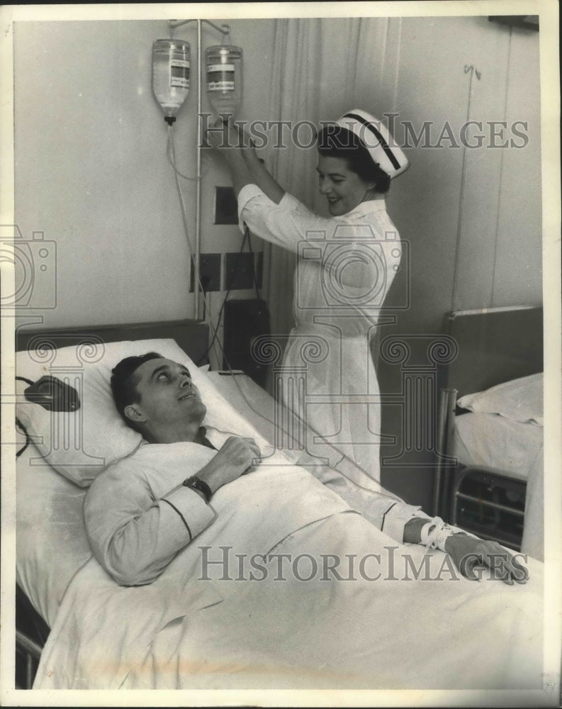 Load image into Gallery viewer, 1959 Press Photo Nurse Margaret Gledbill Adjusts Intravenous Feeding - ney25786
