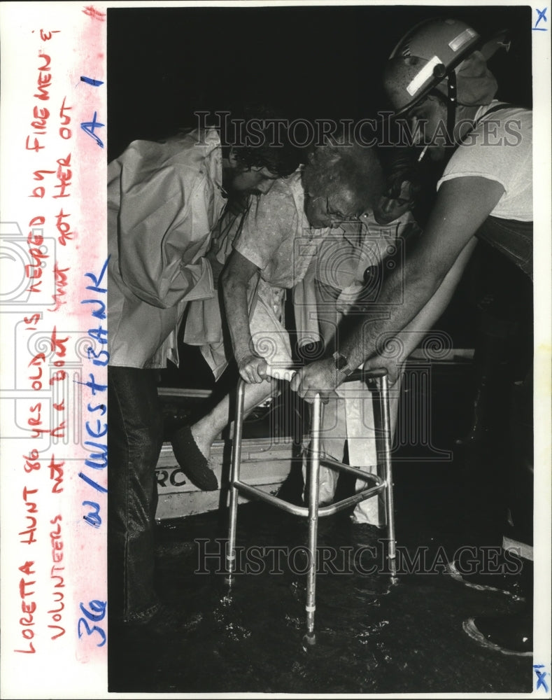 1966 Press Photo Hurricane Juan-Loretta Hunt, 86, helped by firemen. - noa03245- Historic Images