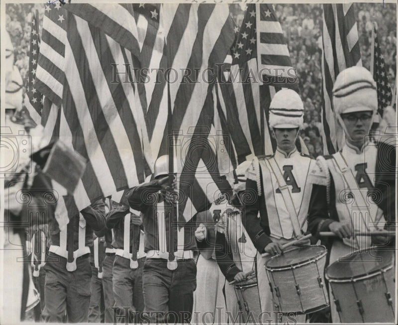 Load image into Gallery viewer, 1967 Press Photo Sugar Bowl- Seabees carry colors through Alabama Band.
