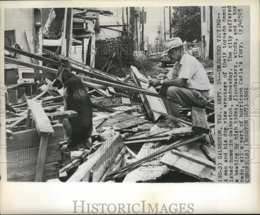1961 Press Photo Hurricane Carla-A man and his dog view wreckage of their home.