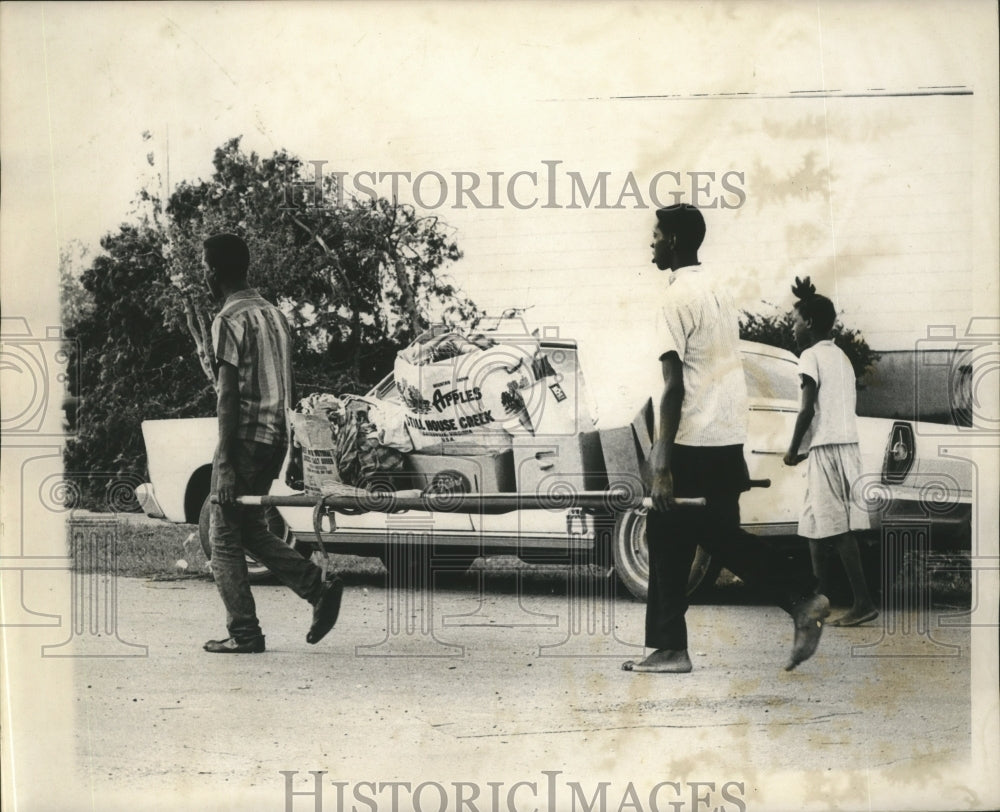 1965 Press Photo Hurricane Betsy- Hauling trash away on a stretcher - noa05863- Historic Images