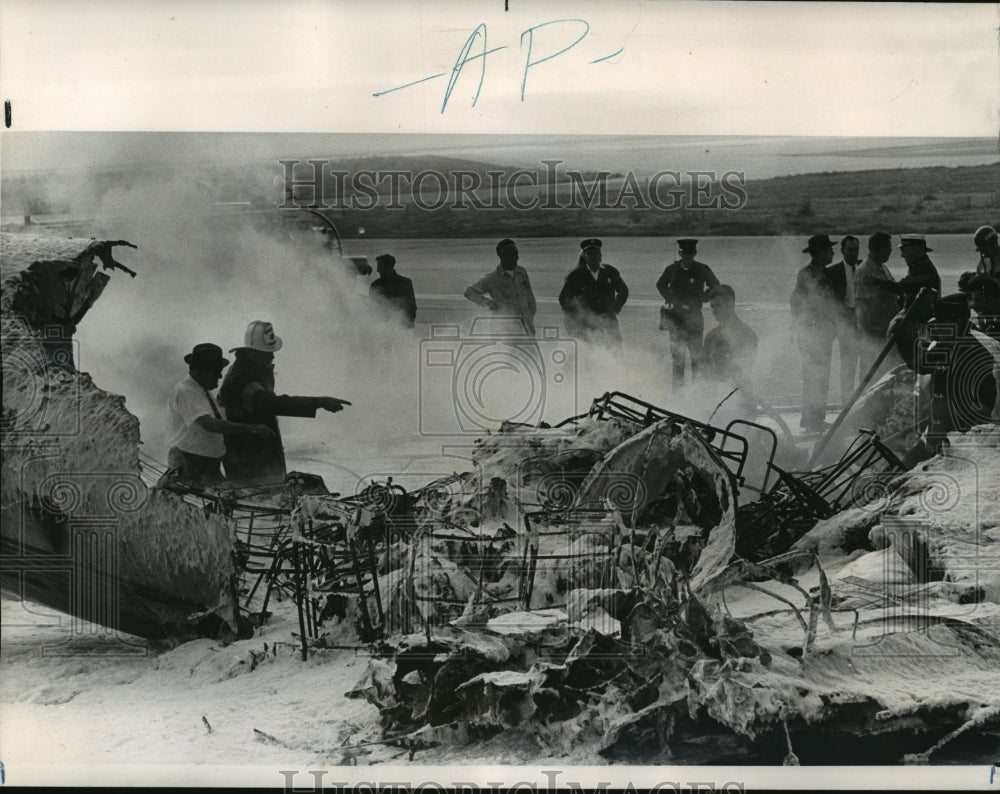 1969 Press Photo Airplane Accidents- Smoldering plane ruins covered foam.- Historic Images