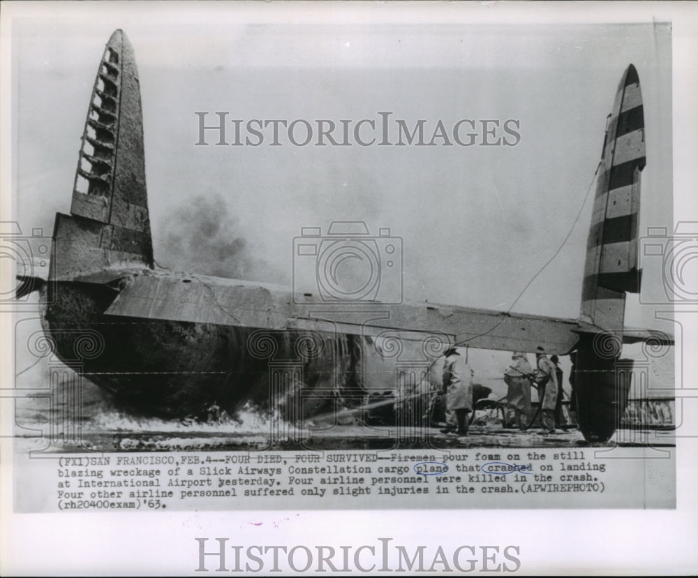 1963 Press Photo Airplane Accidents- Firemen pour foam on wreckage of plane.- Historic Images