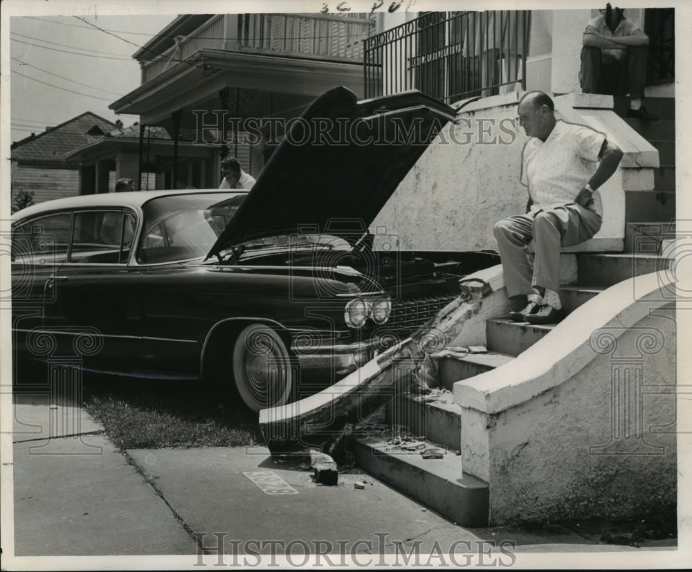 1963 Press Photo A.J. Birou surveys the damage to his late model sedan