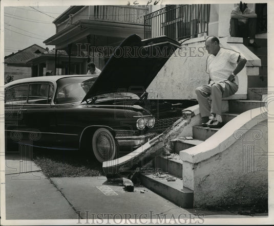 1963 Press Photo A.J. Birou surveys the damage to his late model sedan