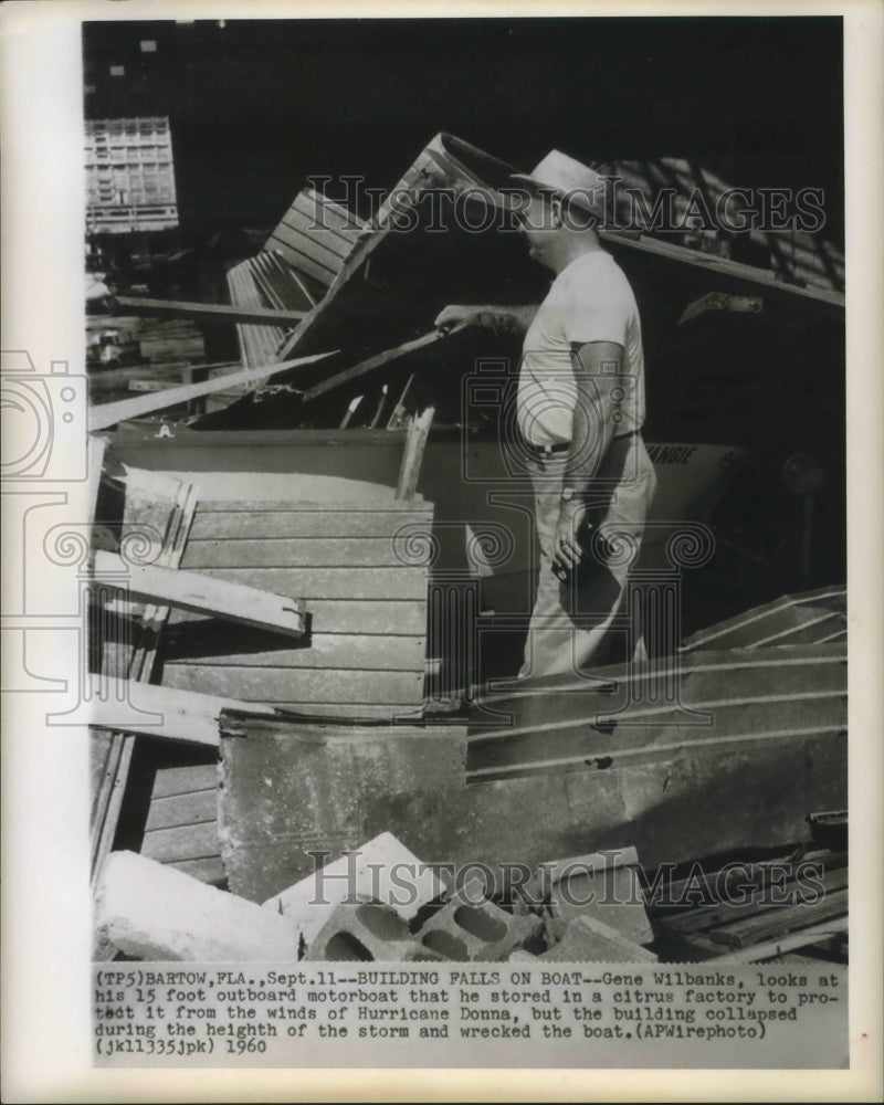 Load image into Gallery viewer, 1960 Press Photo Hurricane Donna - Gene Wilbanks Boat Under Collapsed Building

