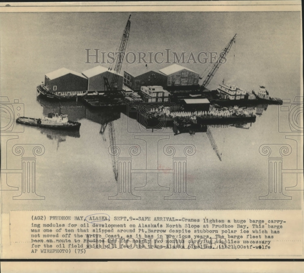 1975 Press Photo Cranes lighten a barge carrying modules for oil development