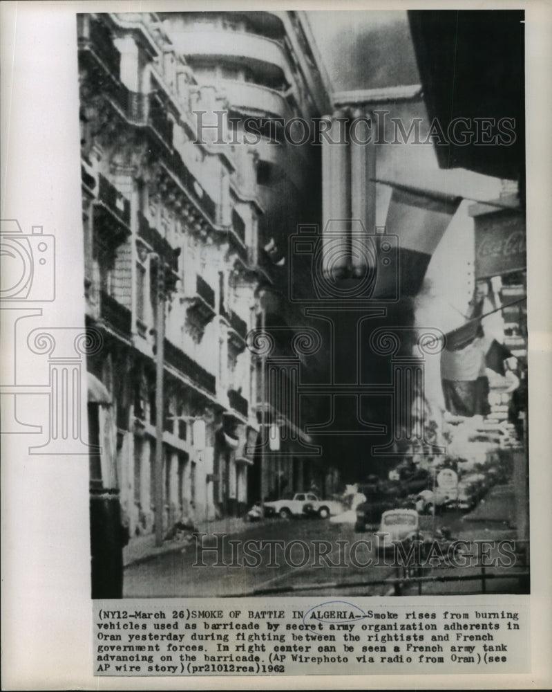 Load image into Gallery viewer, 1962 Press Photo Smoke rises from burning vehicles during fighting in Oran.
