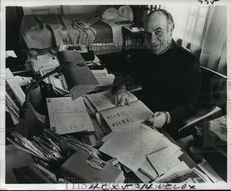 Load image into Gallery viewer, 1975 Press Photo Father Andres Salvador Alvarez at his desk - noa15003
