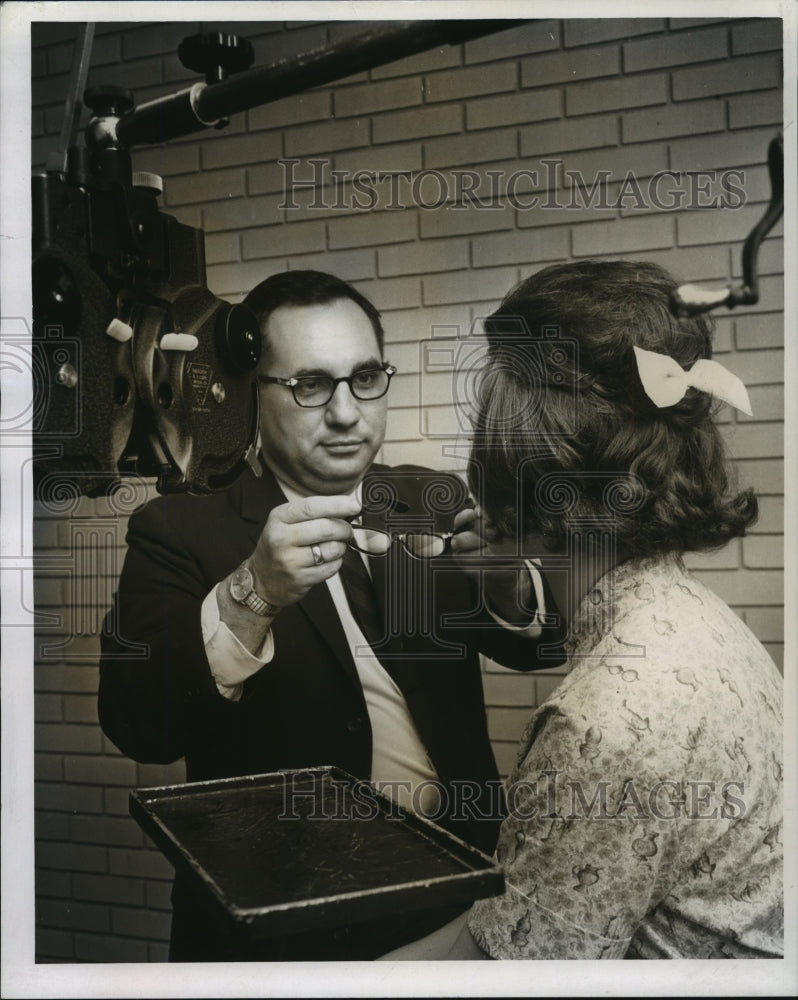 1966 Press Photo Dr. C.J. Andres, Optometrist Fits Glasses for Eunice Patient- Historic Images