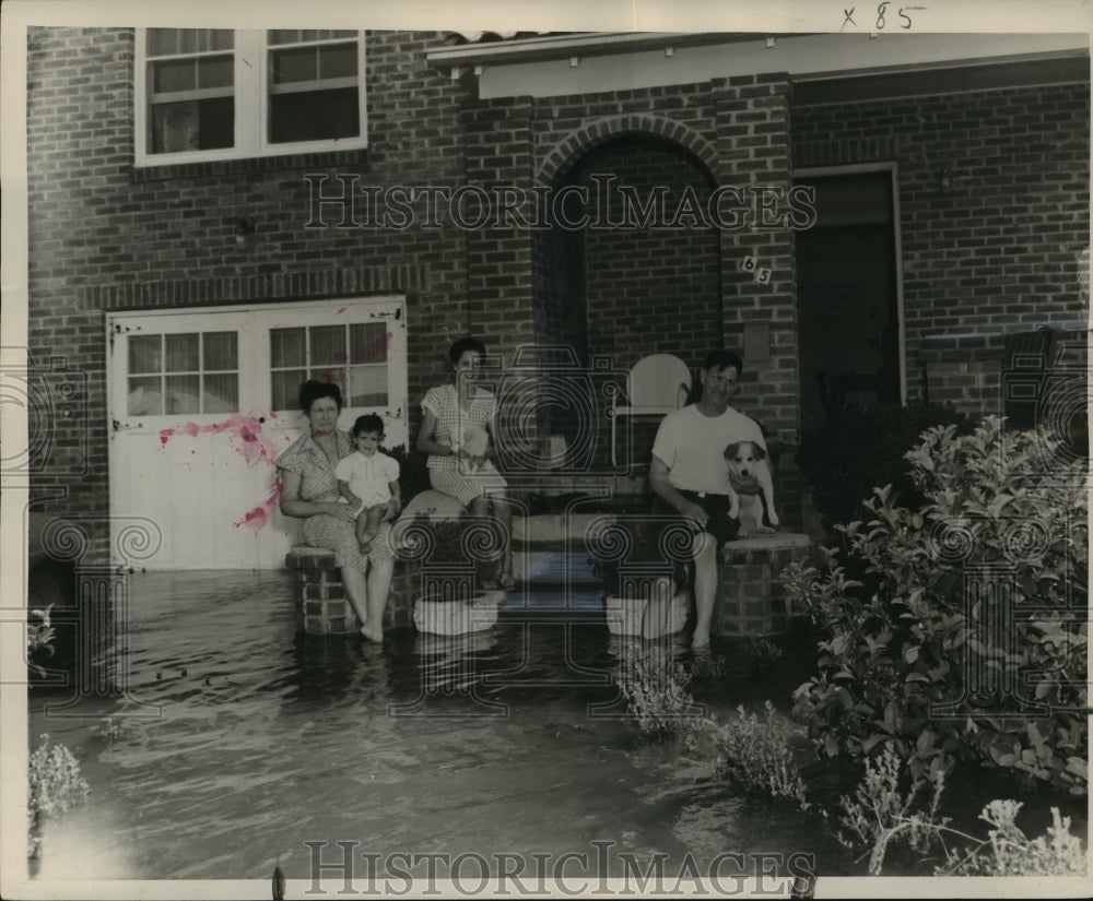 1947 Press Photo New Orleans - Family on Steps Surrounded by Hurricane Flood- Historic Images