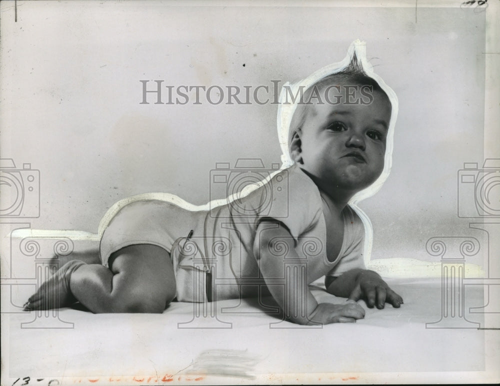 1955 Press Photo Baby Laying on Belly with Hair Standing Up- Historic Images