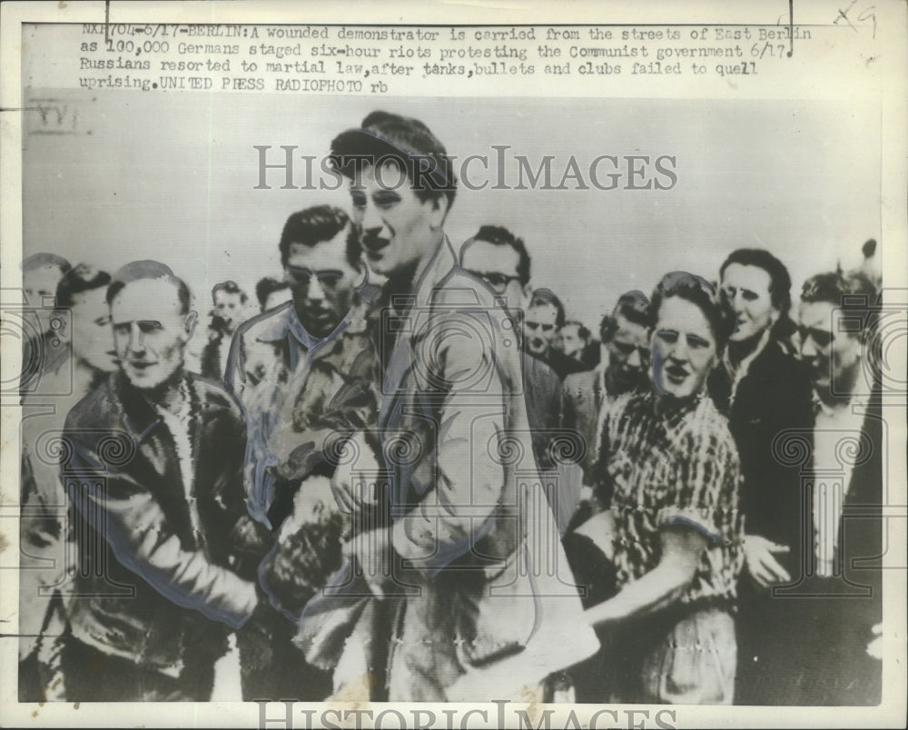 1953 Press Photo Wounded demonstrator carried from the streets of East Berlin