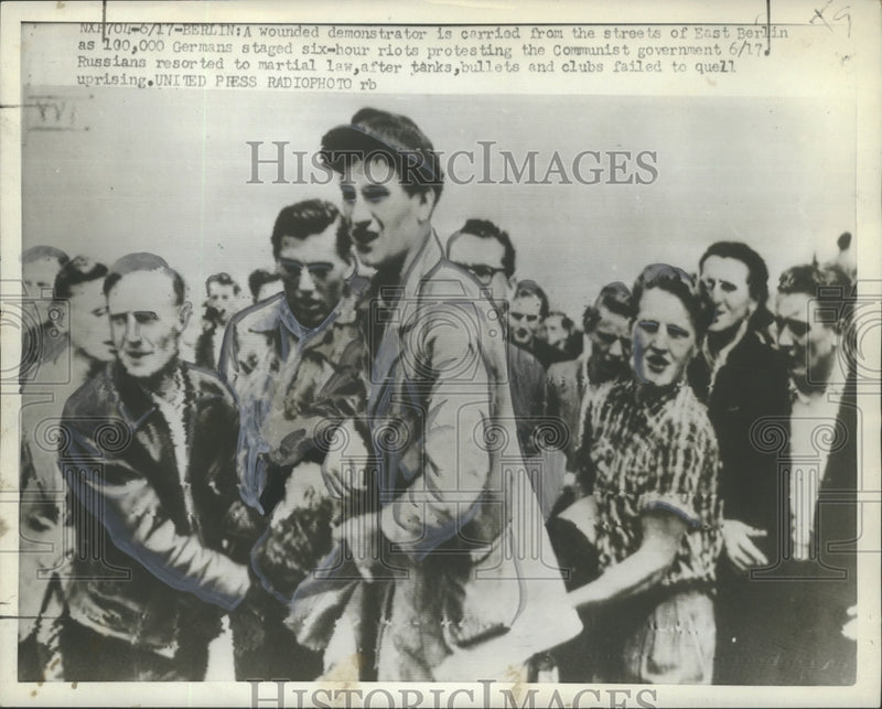 Load image into Gallery viewer, 1953 Press Photo Wounded demonstrator carried from the streets of East Berlin
