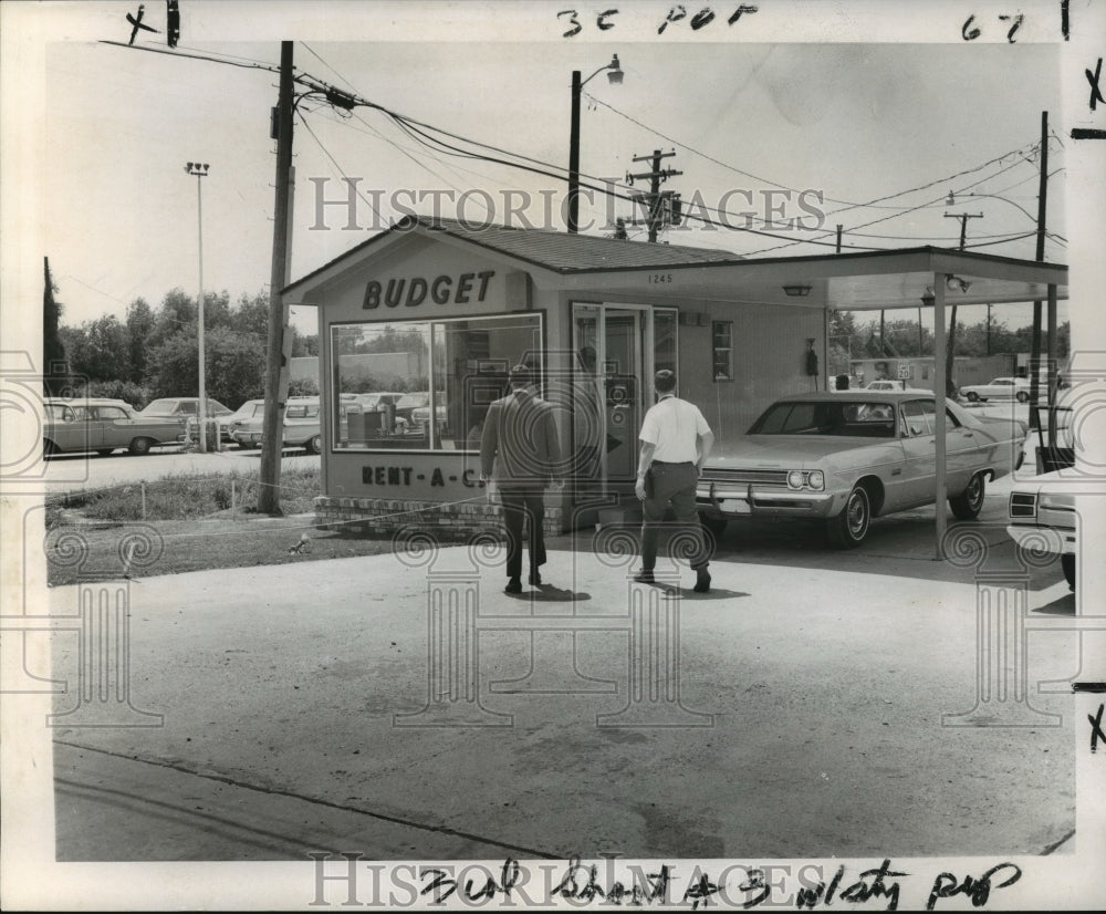 1969 Press Photo Two gentlemen walking into Budget Rent-a-Car office - Historic Images