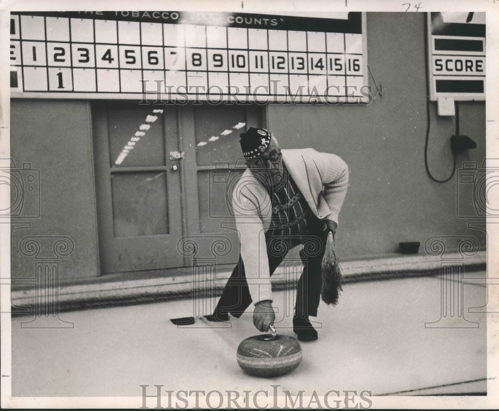 1957 Press Photo An elderly man shown &quot;curling&quot; - noa51963- Historic Images