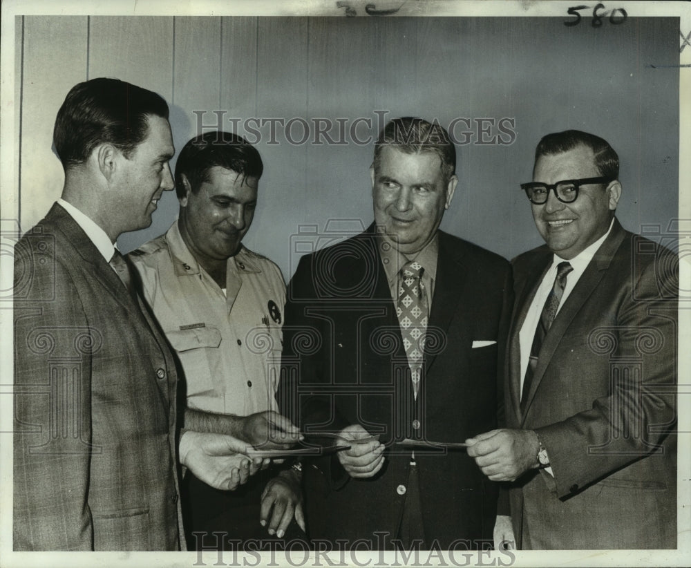 1969 Press Photo Police leaders present checks to Children Football Fund members
