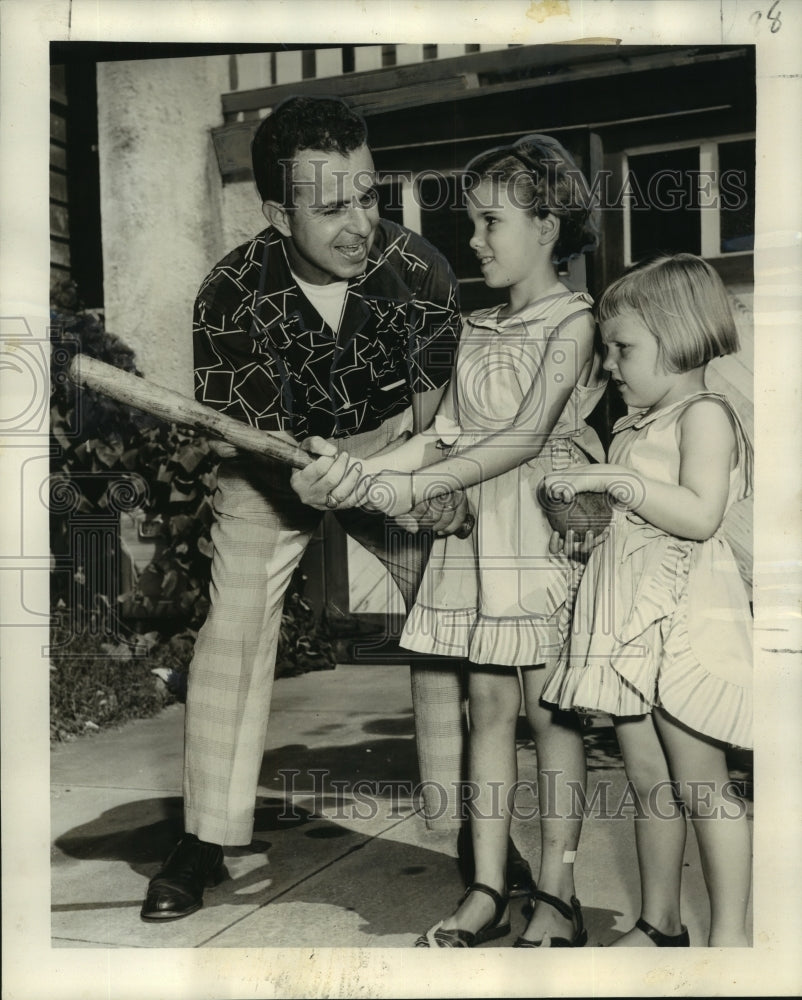 1952 Press Photo The Reverend Palmer Deloteaus and playing with his children