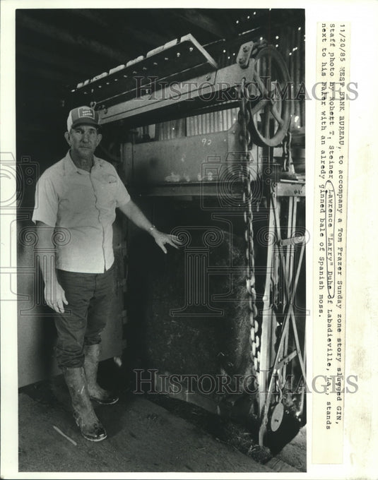 1985 Press Photo Lawrence "Larry" Duhe Stands Next to Spanish Moss Baler- Historic Images