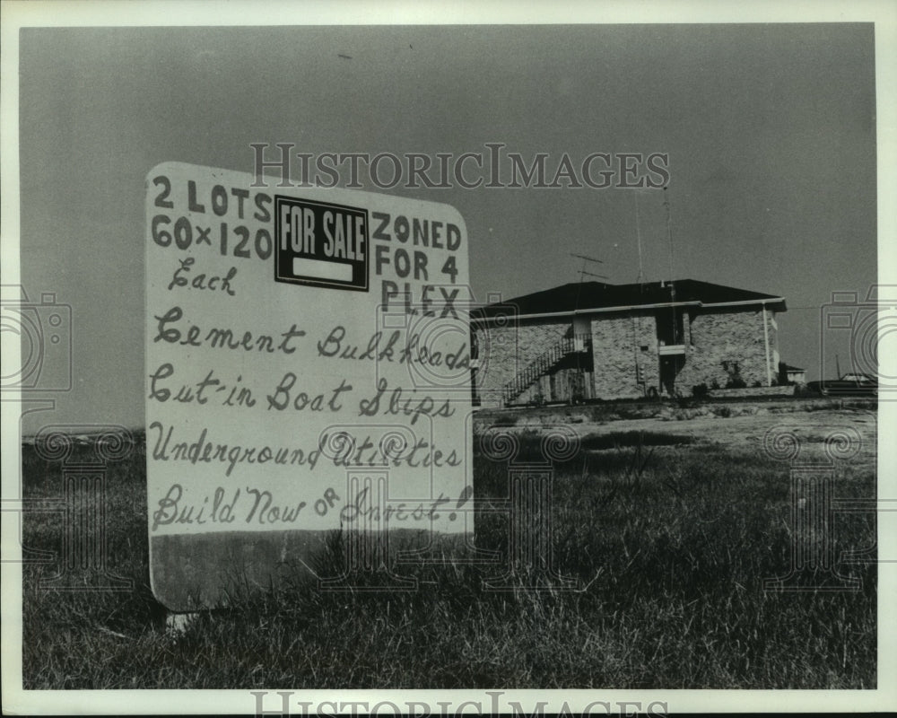  Press Photo Advertising sign for Eden Isles subdivision. Two lots are for sale.- Historic Images