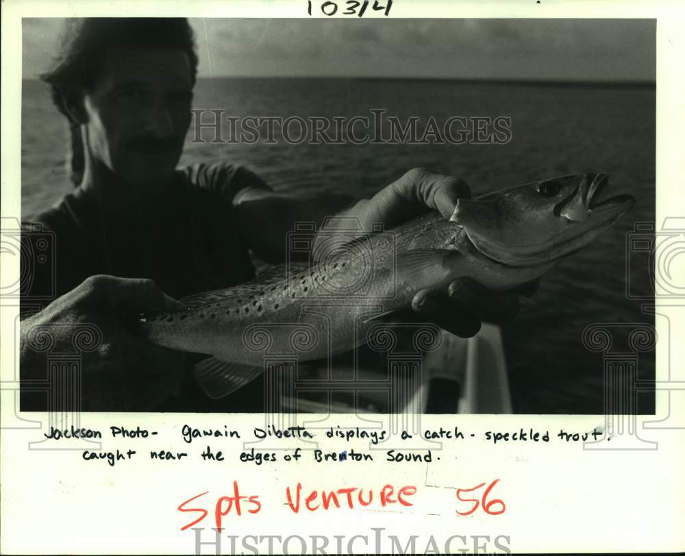 1986 Press Photo Gawain Dibetta displays specked trout caught near Brenton Sound- Historic Images