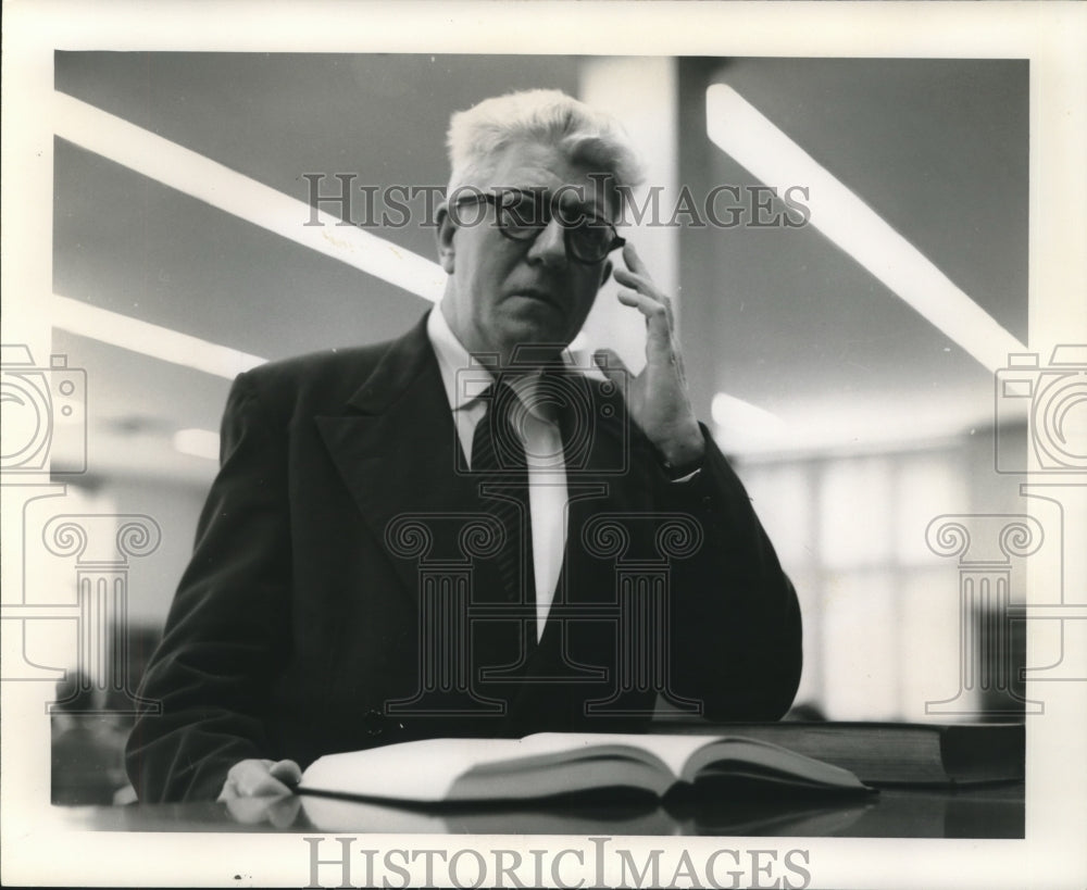  Press Photo James W. Dylan, Librarian of Loyola University adjusts his glasses.- Historic Images