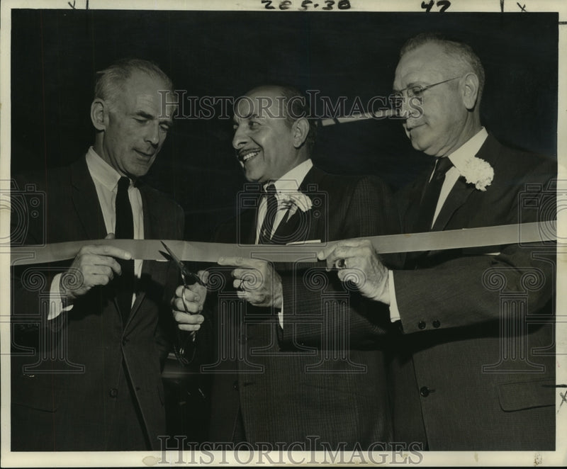 Load image into Gallery viewer, 1961 Press Photo Louis Fernandez &amp; others cut ribbon for import auto dealership
