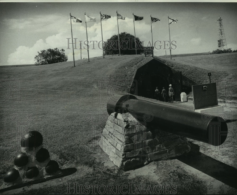 1975 Press Photo Hoisted flags and cannonball at the entrance of Fort Morgan- Historic Images