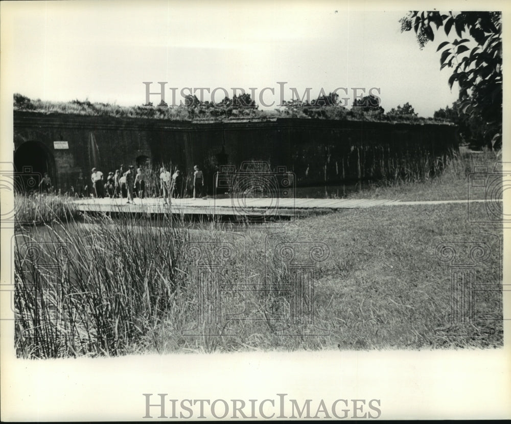 1961 Press Photo Visitors explore and walk grounds of historic fort.