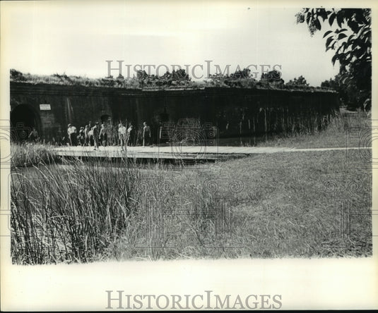 1961 Press Photo Visitors explore and walk grounds of historic fort.