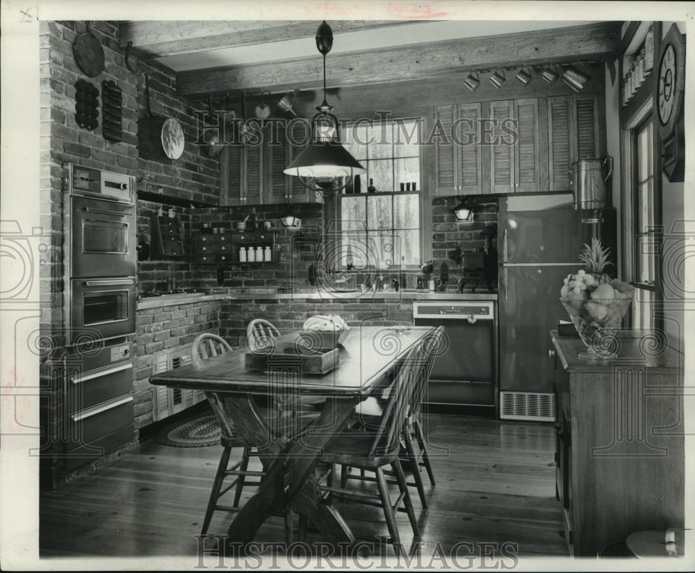 1965 Press Photo Kitchen with copper-tone appliances & trestle table & chairs