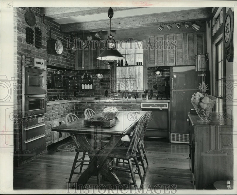 Load image into Gallery viewer, 1965 Press Photo Kitchen with copper-tone appliances &amp; trestle table &amp; chairs
