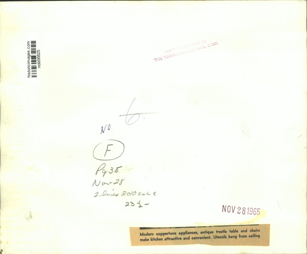 1965 Press Photo Kitchen with copper-tone appliances & trestle table & chairs